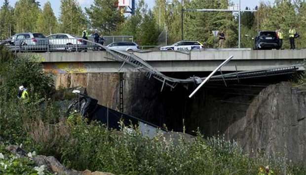 Police are seen at the bridge where a bus collided with cars in Kuopio, Finland, on Friday.