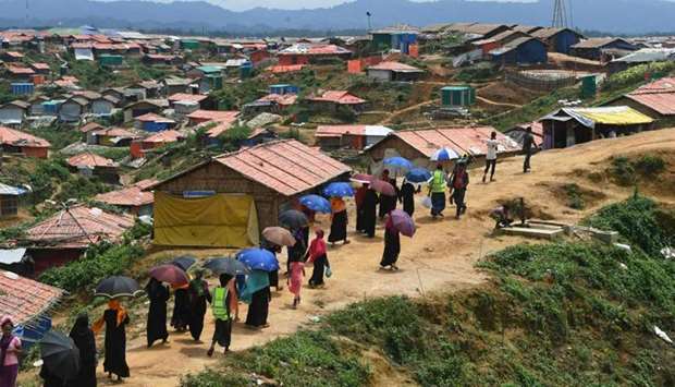 Rohingya refugee volunteers walk along Balukhali refugee camp in Ukhia district near Cox's Bazar. August 23, 2018 file picture.