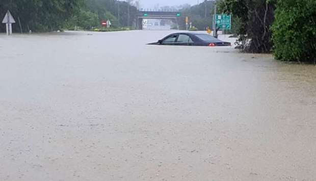 A car submerged in floodwaters caused by heavy rain in Chiayi county, central Taiwan yesterday.  Photo: CNA/AFP