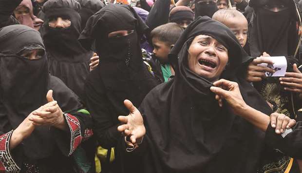 Rohingya refugees burst into tears during a protest march after attending a ceremony to remember the first anniversary of a military crackdown that prompted a massive exodus of people from Myanmar to Bangladesh, at the Kutupalong refugee camp in Ukhia yesterday.