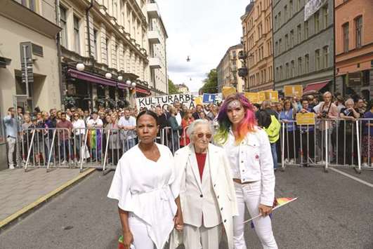 Swedish Minister of Culture Alice Bah Kuhnke, holocaust survivor Hedi Fried, and handball player Linnea Claeson are pictured at the police barrier during a counter-protest against a neo-Nazi demonstration at the Kungsholmstorg square in Stockholm.