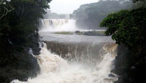 The Wailuku River, swollen from rain from Hurricane Lane, flows near Hilo, Hawaii on Saturday.