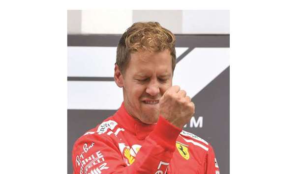 Ferrariu2019s German driver Sebastian Vettel celebrates on the podium after winning the Belgian Formula One Grand Prix at the Spa-Francorchamps circuit yesterday. (AFP)