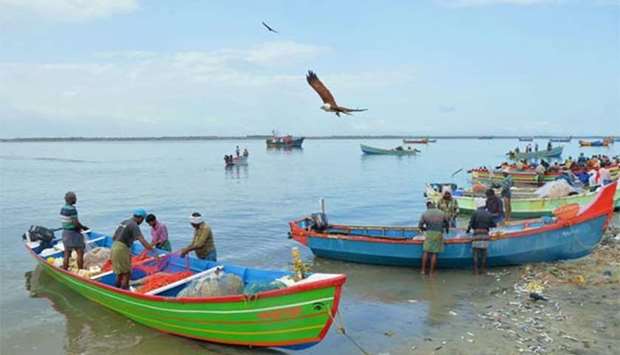 Fishermen return to the shores at Kollam beach in Kerala last week.