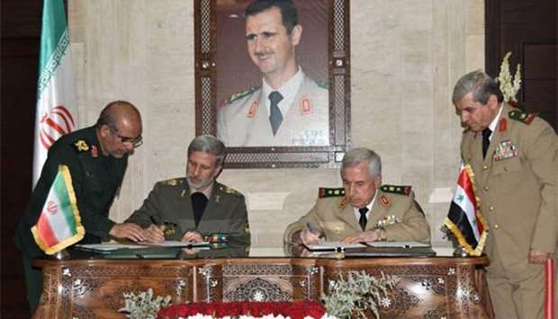 Iranian Defence Minister Amir Hatami (left) and his Syrian counterpart Abdullah Ayoub signing an agreement in Damascus.