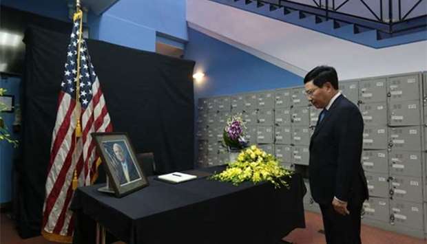 Vietnamese Deputy Prime Minister Pham Binh Minh pays respect to the late US Senator John McCain during a memorial tribute at the US embassy in Hanoi on Monday.