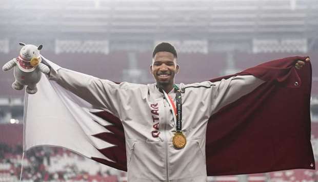 Qatar's Abderrahman Samba celebrates during the victory ceremony for the men's 400m hurdles. AFP