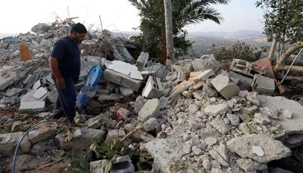 A man walks through the rubble of the family house of Palestinian assailant Mohammed Youssef after it was demolished by Israeli troops in the village of Kobar near Ramallah on Tuesday.