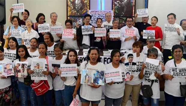 Activists and families of drug war victims display placards during a protest against the war on drugs by President Rodrigo Duterte in Quezon city, Metro Manila on Tuesday.
