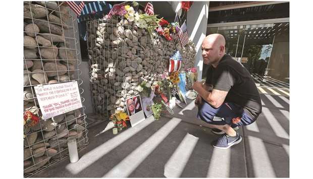 A Phoenix resident pays his respects to the late Sen John McCain as he looks over the notes left at a small memorial outside McCainu2019s office in Phoenix, Arizona.
