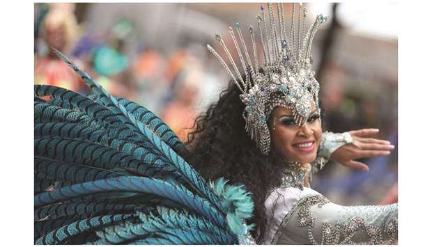 A performer in costume takes part in the carnival on the main parade day of the Notting Hill Carnival in west London.