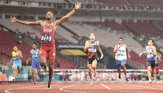 Qataru2019s Abderrahman Samba celebrates after crossing the finish line to win the menu2019s 400m hurdles final during the 2018 Asian Games in Jakarta yesterday. (AFP)