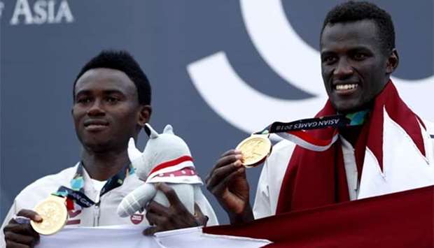 Qatar's gold medalists Sherif Younis and Ahmad Tejan pose on the podium.
