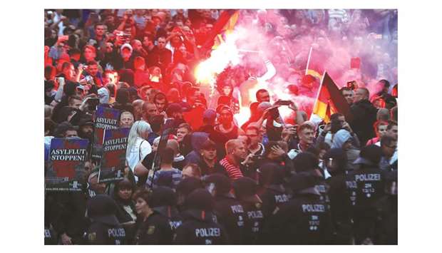This picture taken on Monday shows far-right demonstrators lighting flares during a rally in Chemnitz, eastern Germany.