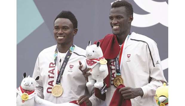 Qatar beach volleyball players Cherif Samba (right) and Ahmed Janko celebrate with their gold medals during the podium ceremony in Palembang, Indonesia, yesterday.