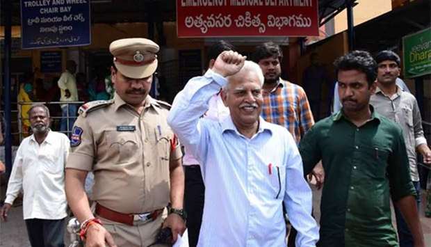 Indian poet and activist Varara Rao gestures as he is escorted by policemen after his arrest in Hyderabad on Tuesday.