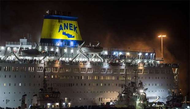 A firefighting vessel tries to extinguish a fire on the ferry Eleftherios Venizelos, at the port of Piraeus in Athens, early on Wednesday.
