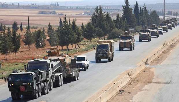 Turkish forces are seen in a convoy on a main highway between Damascus and Aleppo, near the town of Saraqib in Syria's northern Idlib province.
