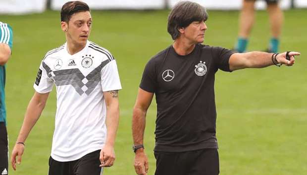 Germany manager Joachim Loew (right) said he was snubbed by Mesut Ozil after the midfielder abruptly retired from international football.