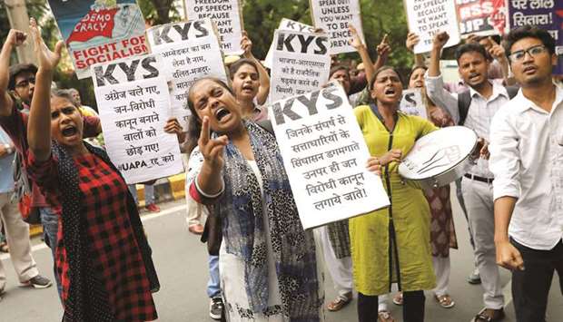 Protesters hold placards as they shout slogans during a demonstration against the arrest of five human rights campaigners, in New Delhi yesterday.