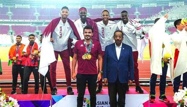 Qatar Olympic Committee president HE Sheikh Joaan bin Hamad al-Thani and Asian Athletics Association president Dahlan al-Hamad pose with Qatar's 4x400m relay gold-winning quartet.