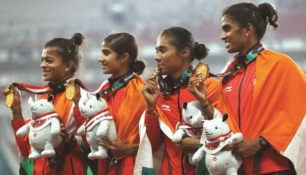 Gold medallists team India pose during the medal ceremony for womenu2019s 4x400m relay at the GBK Main Stadium in Jakarta, Indonesia, yesterday. (Reuters)
