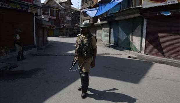 An Indian paramilitary trooper stands guard during a second day of a strike called by Kashmiri separatists in Srinagar on Friday.