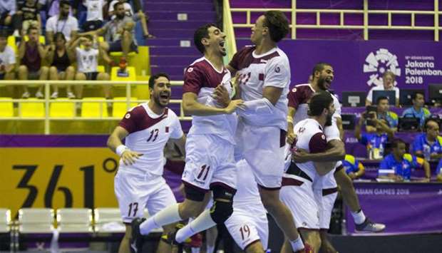 Qatar's team celebrate winning the men's handball match between Qatar and Bahrain at Asian Games in Jakarta