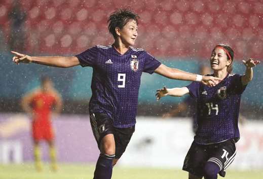 Yuika Sugasawa (left) of Japan celebrates after scoring a goal against China in the womenu2019s football final in Palembang, Indonesia, yesterday. (Reuters)