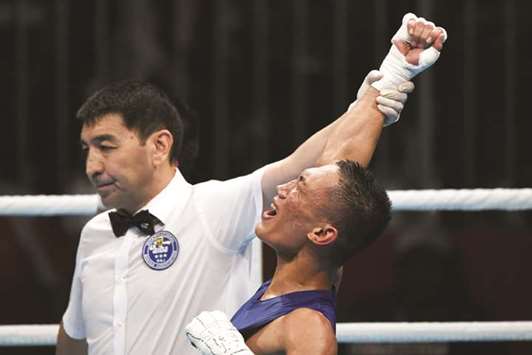 Rogen Ladon of Philippines celebrates his win over Thailandu2019s Yuttapong Tongdee (not pictured) in their menu2019s 52kg semi-finals at the 2018 Asian Games in Jakarta yesterday. (AFP)