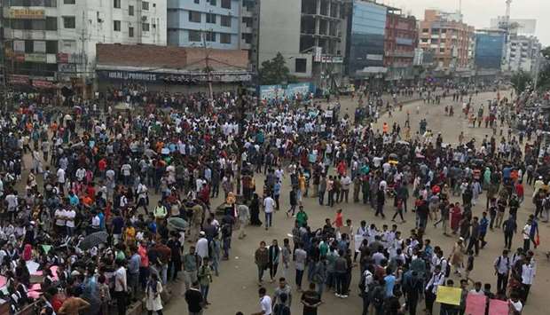 People and students protest yesterday over recent traffic accidents that killed a boy and a girl, in Dhaka, Bangladesh.