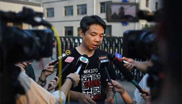 Jiang Hui, whose mother was on board the missing Malaysia Airlines flight MH370, speaks to the media after a meeting with Malaysian officials in Beijing on Friday.