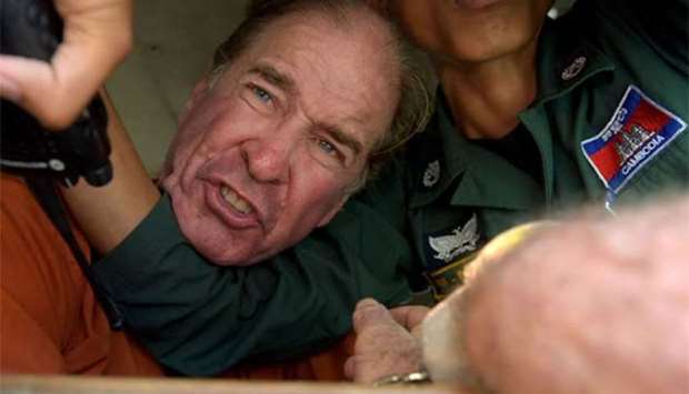 Australian filmmaker James Ricketson reacts as he attempts to speak to journalists from a prison vehicle after his verdict at the Phnom Penh court on Friday.