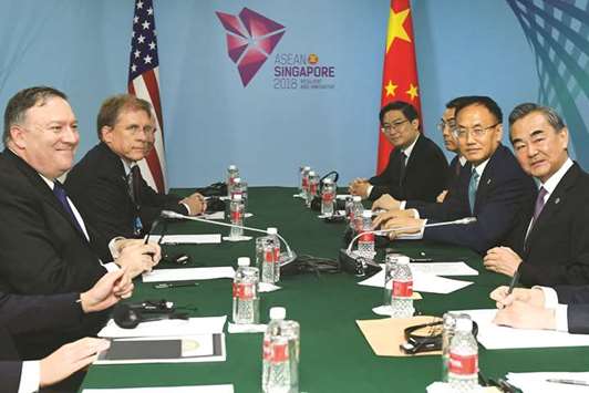 US Secretary of State Mike Pompeo and Chinau2019s Foreign Minister Wang Yi smile before their bilateral meeting at the 51st Association of Southeast Asian Nations (Asean) in Singapore, yesterday.