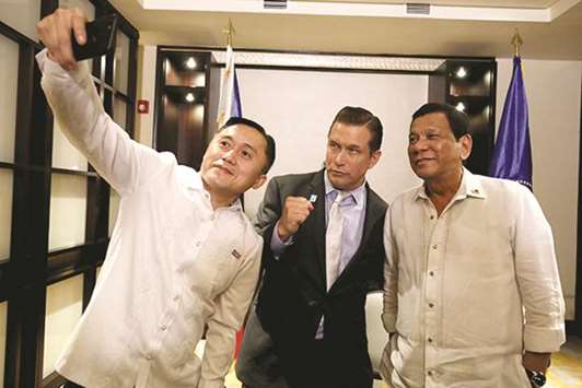 President Rodrigo Duterte and Hollywood actor Stephen Baldwin pose for a selfie with Special Assistant to the President Christopher Lawrence u2018Bongu2019 Go.