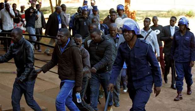 Some of the 16 people detained after police sealed off the building of Opposition Movement for Democratic Change (MDC) on Thursday, appear in court in the capital Harare