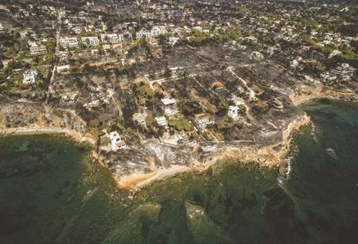 An aerial view shows a burnt area following a wildfire in the village of Mati, near Athens.