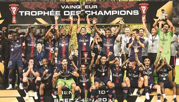 Paris Saint-Germainu2019s captain Thiago Silva holds the trophy as he celebrates with teammates after winning the French Champions Trophy in Shenzhen. (AFP)