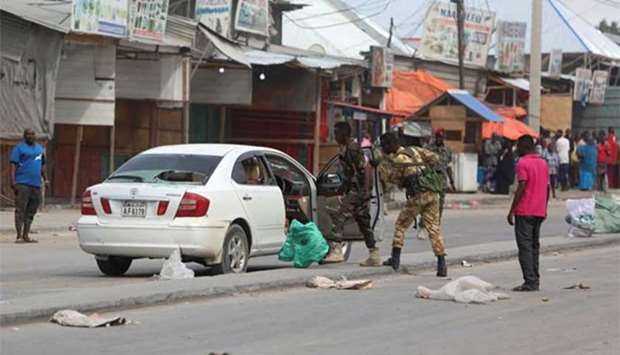 Somali government soldiers inspect a car after two armed militants were killed by Somali forces, at the Benadir checkpoint in Mogadishu on Sunday.
