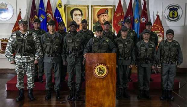 Venezuelan Defence Minister Padrino Lopez (centre) flanked by the military high command, addresses a press conference in Caracas on Sunday, a day after an alleged attack using explosive-laden drones during a military parade.