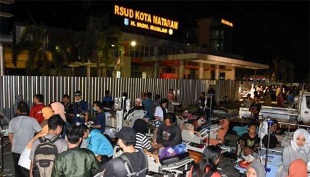 Patients are evacuated from the Mataram City hospital parking lot after a strong earthquake in Mataram, Lombok island on Sunday.