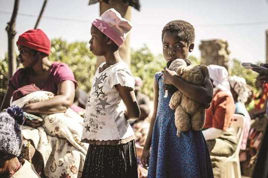 Children attend the funeral ceremony of Ishmael Kumire, 42, shot during post-election violence on August 1 in Harare, at his homestead in Chinamhora village, Domboshava, outside the Zimbabwean capital Harare.