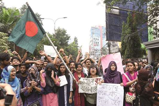 Bangladeshi students shout slogans as they march along a street during a protest in Dhaka yesterday.