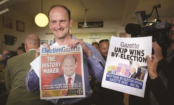 This 2014 file picture shows former Ukip MP Douglas Carswell with a copy of the local newspaper after he won the Clacton-on-Sea by-election.