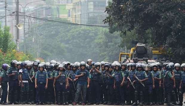 Bangladeshi police stand guard during a student protest in Dhaka yesterday.