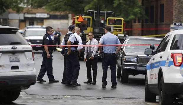 Chicago Police officers and detectives investigate a shooting where multiple people were shot in Chicago