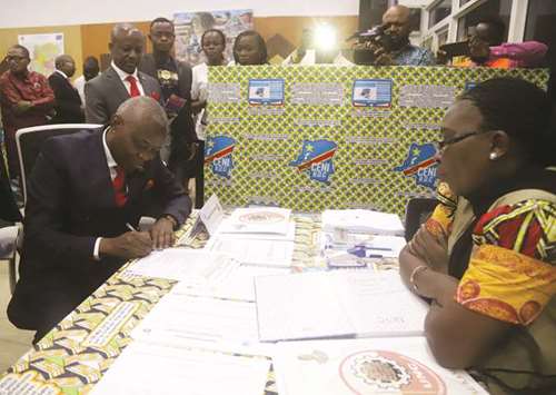 Congolese opposition candidate Vital Kamerhe files his candidacy for the presidential election, at the Congou2019s electoral commission (CENI) head offices at the Gombe Municipality in Kinshasa yesterday.