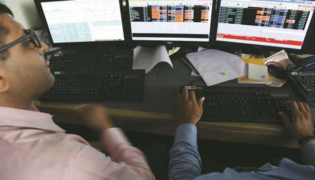 Traders are seen at the Bombay Stock Exchange. The Sensex climbed 0.4% to 37,691.89 at close in Mumbai yesterday.