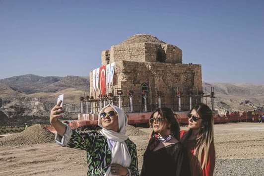 Women take a u2018wefieu2019 as the Artuklu Hamam, a centuries-old bath house weighing 1,600 tonnes, is loaded onto a wheeled platform and moved down a specially-constructed road from the southeastern town of Hasankeyf to a new location.
