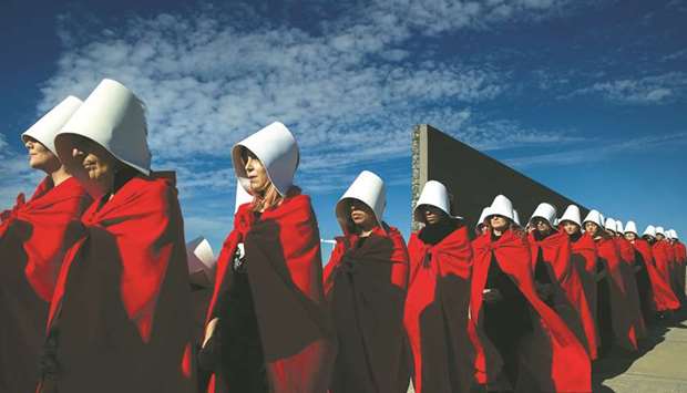Activists in favour of the legalisation of abortion disguised as characters from Canadian author Margaret Atwoodu2019s feminist dystopian novel The Handmaidu2019s Tale, perform at the u201cParque de la Memoriau201d (Remembrance Park) in Buenos Aires.